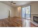 Spacious living room with sliding glass door, fireplace and wood floors at 4960 Harrison Dr # 214, Las Vegas, NV 89120