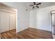An empty living room with wood floors, white walls, with a closet, and stainless steel fridge at 4960 Harrison Dr # 214, Las Vegas, NV 89120