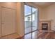 Living room featuring wood floors, a fireplace, and access to a private patio through sliding glass doors at 4960 Harrison Dr # 214, Las Vegas, NV 89120