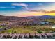 Expansive aerial shot showcasing a community with golf course, mountains and city skyline at 499 Eagle Vista Dr, Henderson, NV 89012