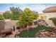Lush backyard putting green with rock features, mature landscaping, and ample space for outdoor enjoyment at 499 Eagle Vista Dr, Henderson, NV 89012