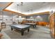 Billiard room with pool tables, comfortable seating, and elegant lighting, perfect for leisure and entertainment at 499 Eagle Vista Dr, Henderson, NV 89012