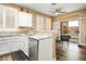 Bright kitchen features stainless steel appliances, granite countertops, and access to the backyard pool at 499 Eagle Vista Dr, Henderson, NV 89012