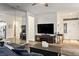 Inviting living room with modern furnishings, a large TV, and contemporary flooring at 499 Eagle Vista Dr, Henderson, NV 89012