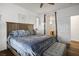 This main bedroom features beautiful flooring, a king bed, and an ensuite bathroom at 499 Eagle Vista Dr, Henderson, NV 89012
