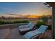 Covered patio area features comfortable lounge chairs perfect for relaxation and outdoor enjoyment at 499 Eagle Vista Dr, Henderson, NV 89012