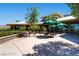 Outdoor patio area with tables, chairs, and umbrellas, offering a relaxing space to enjoy the views at 499 Eagle Vista Dr, Henderson, NV 89012