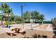 Outdoor shuffleboard courts with benches, picnic tables, and shade, perfect for social gatherings and recreation at 499 Eagle Vista Dr, Henderson, NV 89012