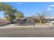 Single-story home with mature trees and a concrete driveway at 5101 Churchill Ave, Las Vegas, NV 89107