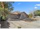 Street view of a home, showing its driveway and drought-tolerant landscaping at 5101 Churchill Ave, Las Vegas, NV 89107