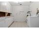 Functional laundry room featuring tile floors, storage, and essential appliances at 5101 Churchill Ave, Las Vegas, NV 89107