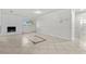Bright living room with large tile flooring, freshly painted walls and a brick fireplace at 5101 Churchill Ave, Las Vegas, NV 89107