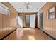 Living room with wood-look floors, wood-paneled walls, and doors leading to other rooms at 5101 Churchill Ave, Las Vegas, NV 89107