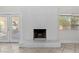 Bright living room with a painted brick fireplace and tile flooring at 5101 Churchill Ave, Las Vegas, NV 89107