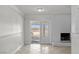 Living room with tile floors, fireplace and glass doors at 5101 Churchill Ave, Las Vegas, NV 89107