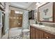 Bathroom featuring granite countertop, cabinet storage, and a shower-tub combo at 5876 Tippin Dr, Las Vegas, NV 89130