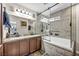 Bathroom showcasing granite countertops, a large tub, and a glass shower at 5876 Tippin Dr, Las Vegas, NV 89130