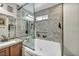 Modern bathroom with double sinks, granite counters, and a shower tub at 5876 Tippin Dr, Las Vegas, NV 89130