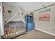 Charming Bedroom featuring a crib with canopy, a blue dresser, and whimsical decor at 5876 Tippin Dr, Las Vegas, NV 89130