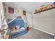 Bedroom showcasing a blue bed with stuffed animals, with open wall shelf at 5876 Tippin Dr, Las Vegas, NV 89130
