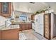 Well-lit kitchen with granite countertops, modern appliances, and tile flooring at 5876 Tippin Dr, Las Vegas, NV 89130