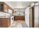 Well lit kitchen featuring granite counters, white appliances, and updated cabinets at 5876 Tippin Dr, Las Vegas, NV 89130