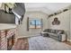 Cozy living room with a brick fireplace and a comfortable gray sofa near a window at 5876 Tippin Dr, Las Vegas, NV 89130