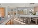 Bright dining room with modern chandelier, large windows, and stylish decor at 59 Desert Dawn Ln, Henderson, NV 89074