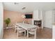 Elegant dining room with a fireplace, designer lighting, and a textured accent wall at 59 Desert Dawn Ln, Henderson, NV 89074