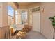 Inviting front porch featuring a cozy sitting area and an abundance of natural light at 59 Desert Dawn Ln, Henderson, NV 89074