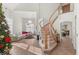 Bright living room featuring a grand staircase, tile floors, and an open floor plan with abundant natural light at 59 Desert Dawn Ln, Henderson, NV 89074