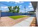 Backyard featuring an artificial lawn, privacy fence, landscaping, storage shed, and covered patio at 6229 Cromwell Ave, Las Vegas, NV 89107
