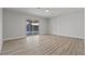 Large bedroom with sliding glass doors and wood-look flooring at 6229 Cromwell Ave, Las Vegas, NV 89107