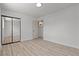 Bright bedroom with laminate floors, neutral colored walls, closet with mirrored doors, and overhead lighting at 6229 Cromwell Ave, Las Vegas, NV 89107