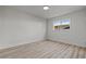 Bedroom featuring laminate floors, base molding, neutral colored walls, and window with outside views at 6229 Cromwell Ave, Las Vegas, NV 89107