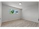 Bedroom with view of backyard through window and wood-look floors at 6229 Cromwell Ave, Las Vegas, NV 89107