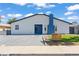 Exterior view of a single-story home with modern landscaping, a blue front door, and a freshly painted exterior at 6229 Cromwell Ave, Las Vegas, NV 89107