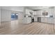 Open-concept floorplan with a modern kitchen and sleek sliding glass doors at 6229 Cromwell Ave, Las Vegas, NV 89107