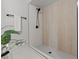 Close-up of shower with wood-look tile and black shower head at 6229 Cromwell Ave, Las Vegas, NV 89107