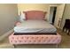 Charming bedroom with a unique pink tufted bed frame, creating a cozy retreat at 6700 Oak Valley Dr, Las Vegas, NV 89103