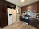 Modern kitchen with dark cabinetry, stainless steel appliances, and a stylish backsplash at 6700 Oak Valley Dr, Las Vegas, NV 89103