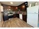 Functional kitchen featuring stainless steel appliances, stylish backsplash and dark wood cabinetry at 6700 Oak Valley Dr, Las Vegas, NV 89103