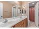 Bathroom with double sink vanity, granite countertop and shower with curtain at 6954 Jacksboro Ct, North Las Vegas, NV 89084