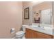 Cozy powder room with a pedestal sink and framed art adding charm to the space at 6954 Jacksboro Ct, North Las Vegas, NV 89084