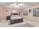 Cozy bedroom featuring a ceiling fan, large window, and neutral tones at 6954 Jacksboro Ct, North Las Vegas, NV 89084