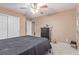 Cozy bedroom with carpet floors, ceiling fan, closet and access to an adjoining area at 6954 Jacksboro Ct, North Las Vegas, NV 89084