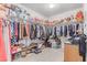 Walk-in closet with ample storage space including shelving, racks, and space for shoes and accessories at 6954 Jacksboro Ct, North Las Vegas, NV 89084
