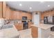 Well-lit kitchen featuring wooden cabinetry, granite countertops, and stainless steel appliances at 6954 Jacksboro Ct, North Las Vegas, NV 89084