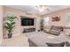 Cozy living room features comfortable sectional sofa and a ceiling fan at 6954 Jacksboro Ct, North Las Vegas, NV 89084