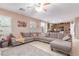 Spacious living room with a large sectional sofa and tiled floors at 6954 Jacksboro Ct, North Las Vegas, NV 89084